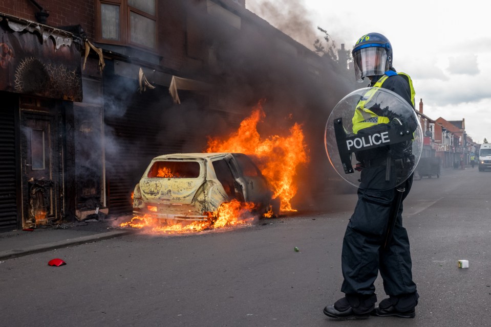 A car burns after it was set alight by far-right activists holding a demonstration in Middlesbrough