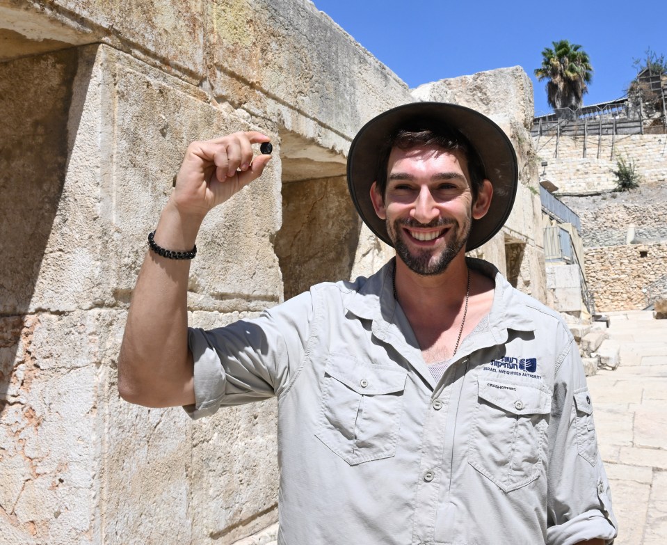 Archeologist Rom Navot, from the Israel Antiquities Authority, holds the rare black stone seal