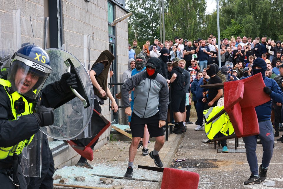 Police take shelter as they are attacked by a far right mob in Rotherham