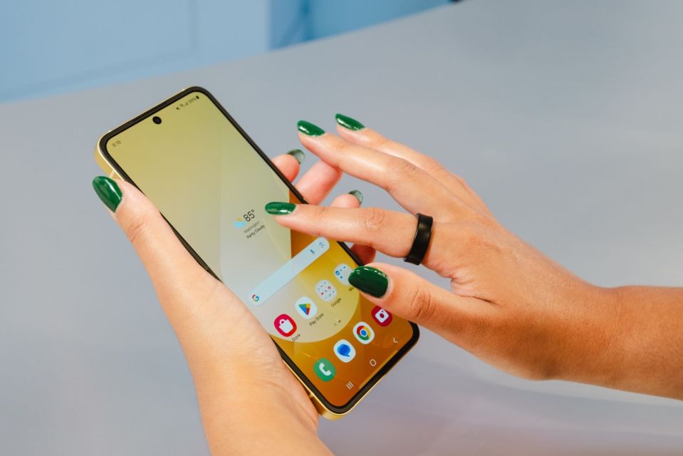 a person with green nails is using a phone that shows the time as 8:51