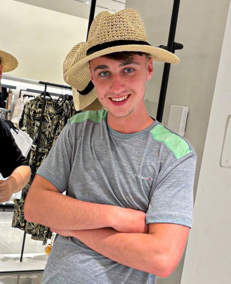 a young man wearing a gray t-shirt with the word tommy on it