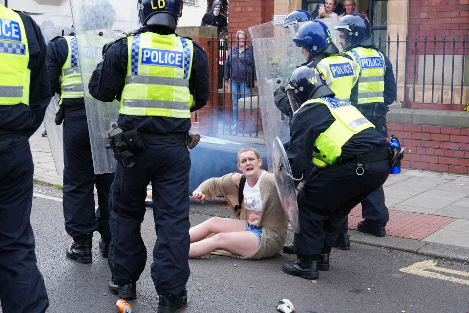 Stacey Vint being detained by police