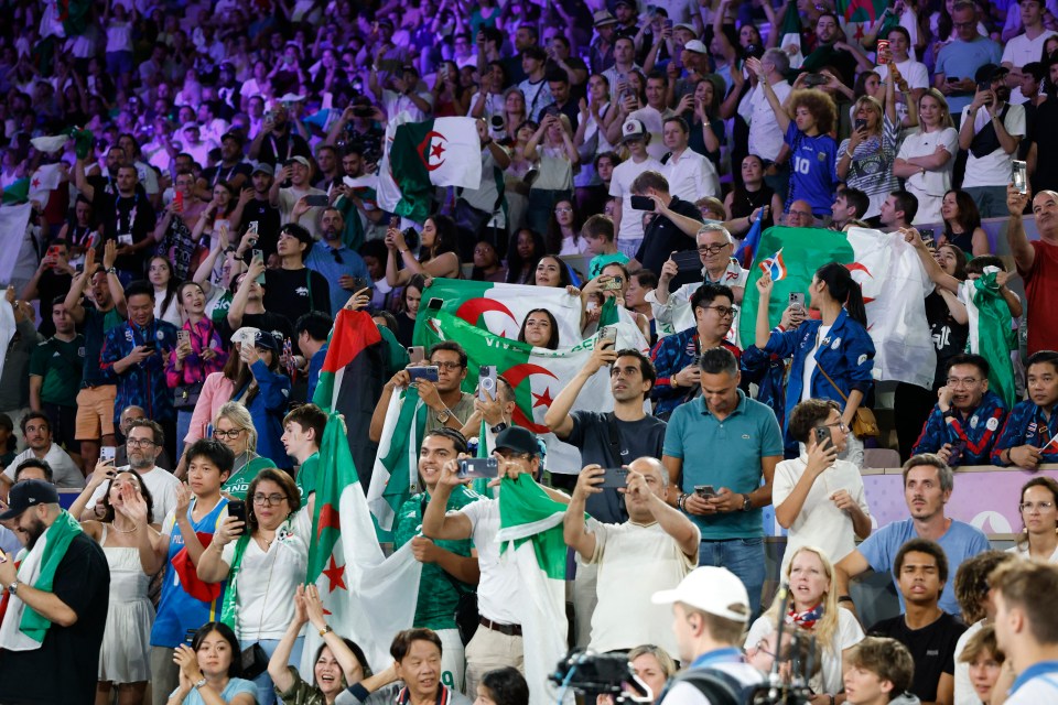 a crowd of people in a stadium with the number 10 on their shirt