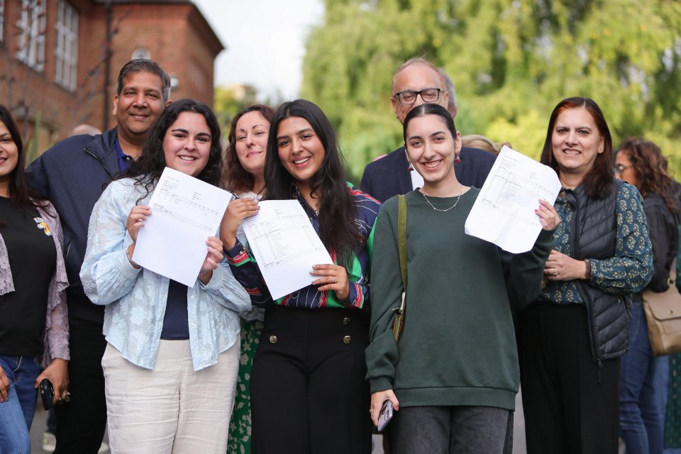 Students posing with their certificates at the school