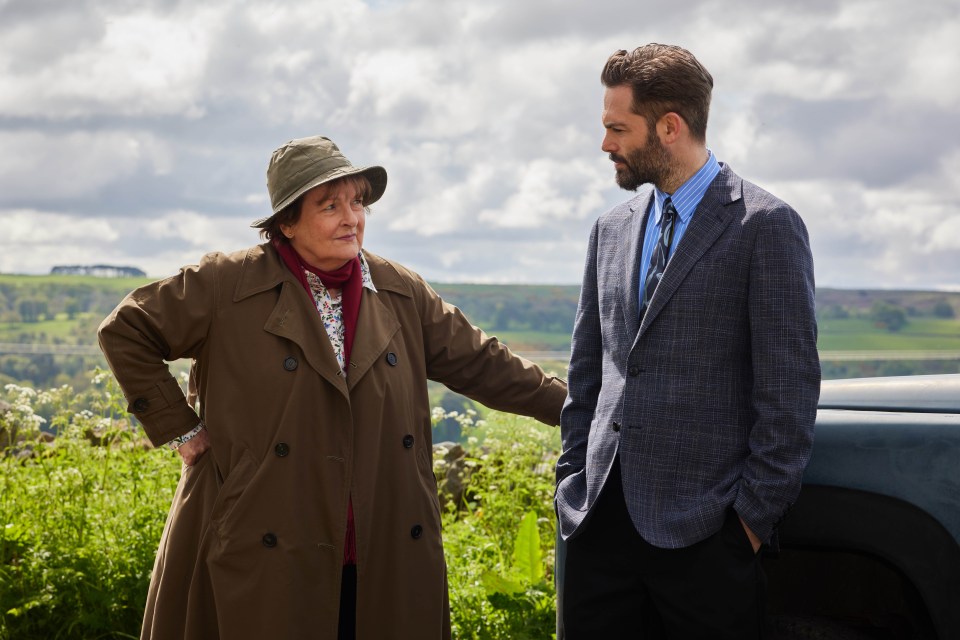 a man and a woman are standing next to each other