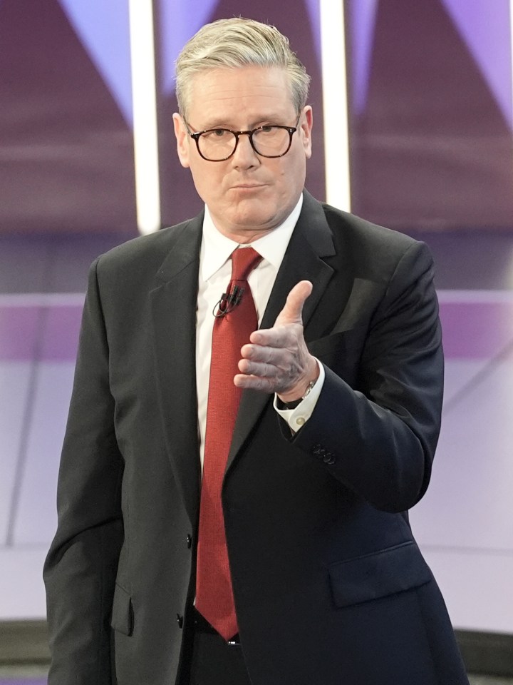 a man in a suit and tie giving a thumbs up