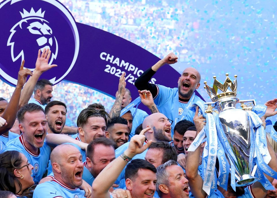 a group of soccer players holding a trophy in front of a banner that says champion