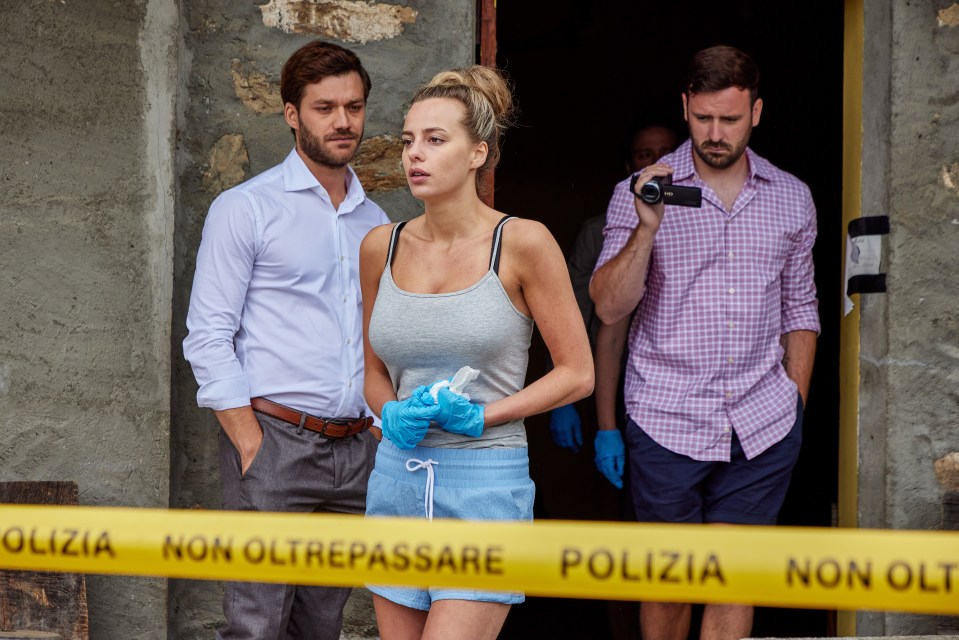 a man is taking a picture of a woman behind a yellow tape that says ' polizia non oltrepassare '