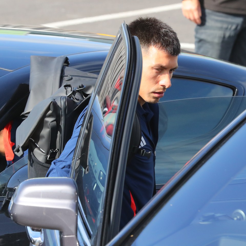 a man getting out of a car with a backpack on his back