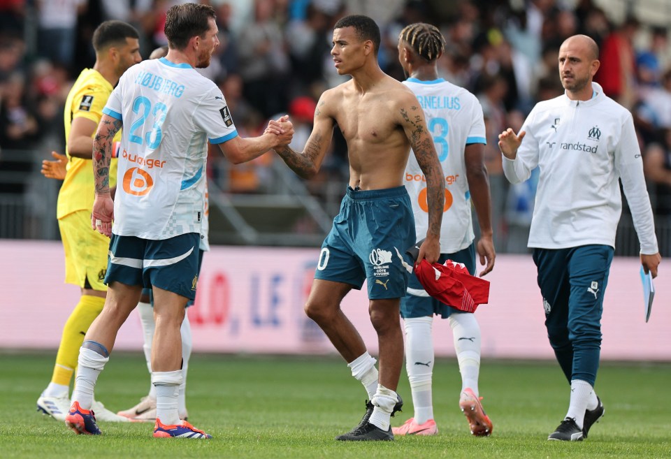 player number 23 shakes hands with another player