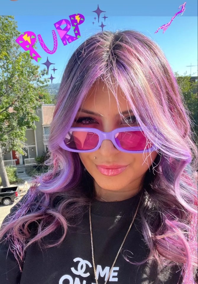 a woman with purple hair is wearing sunglasses and a chanel shirt