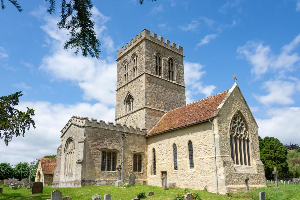 a church with a tower and a cross on top of it