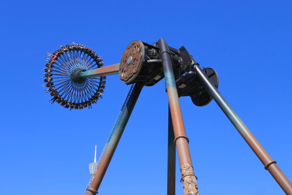 a roller coaster with a blue sky in the background