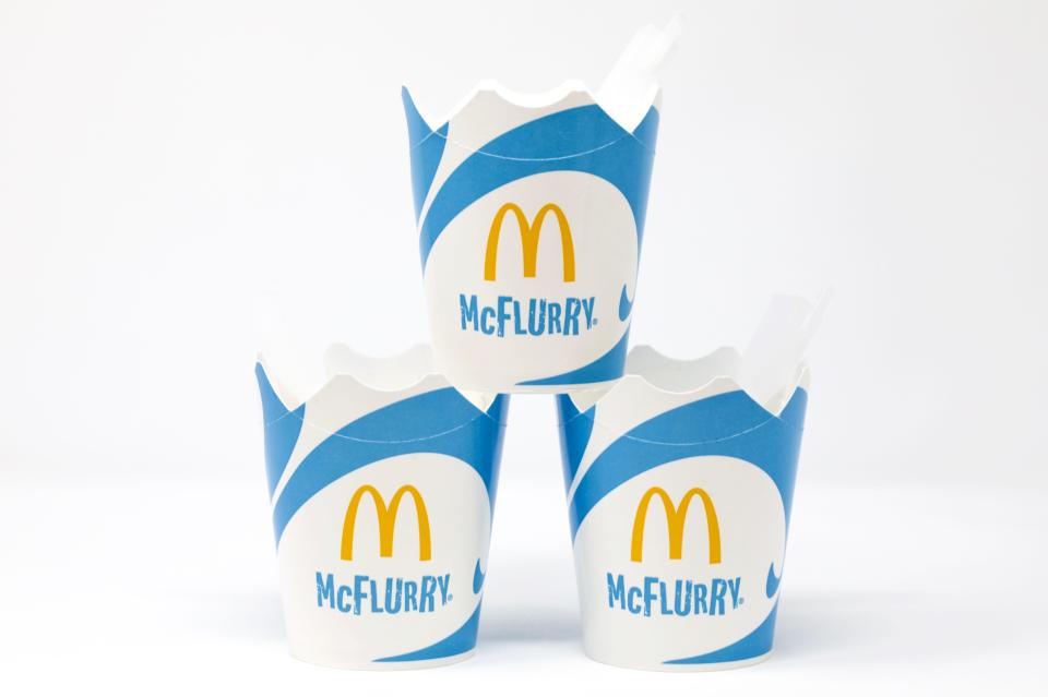 three mcdonald 's cups are stacked on top of each other