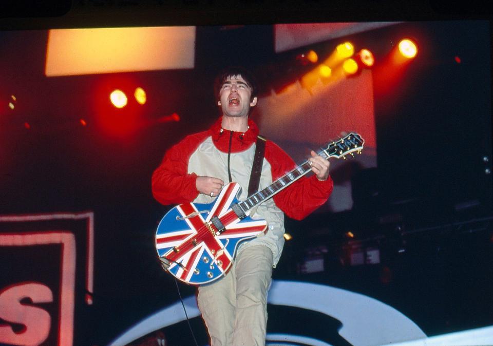 a man playing a guitar with a british flag on it