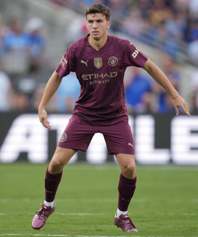 a soccer player wearing a purple etihad airways jersey