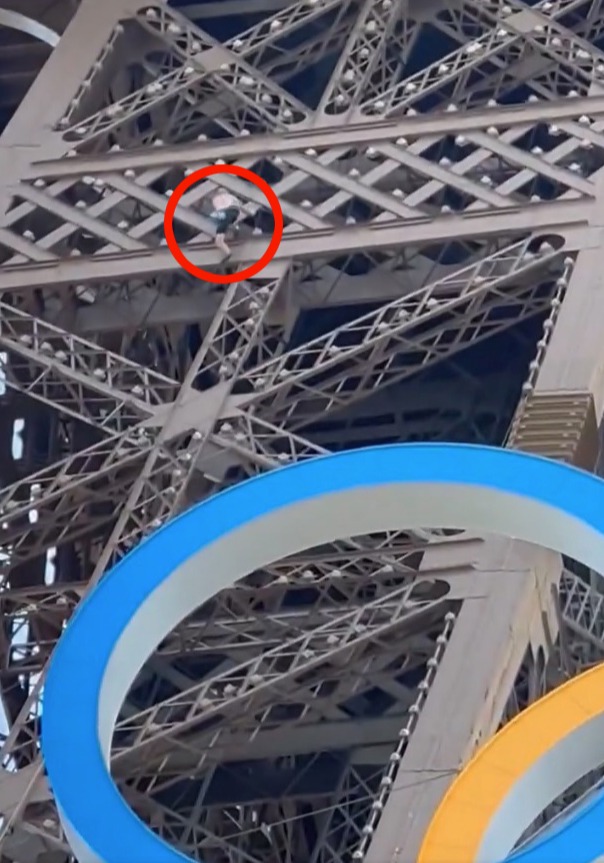 A man has been caught climbing up the Eiffel Tower just hours before the closing ceremony for the Olympics