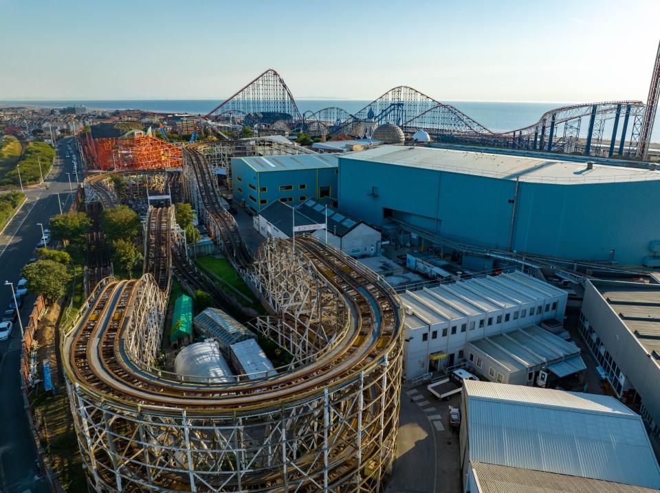 an aerial view of a roller coaster at an amusement park