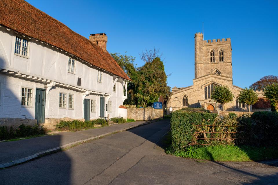 a church with a blue sign that says ' catholic church ' on it