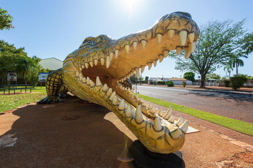 a large statue of a crocodile with its mouth open