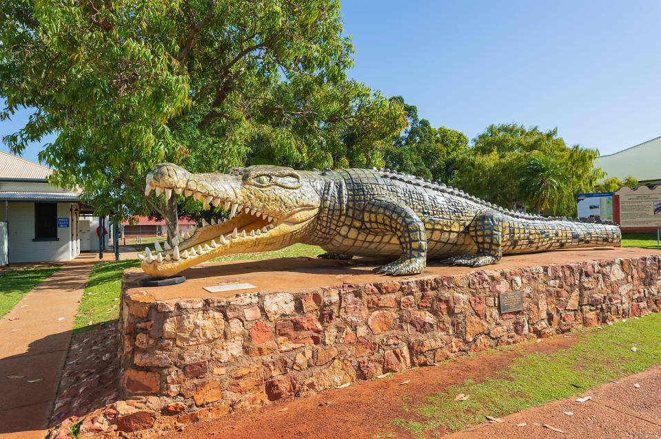 a large statue of a crocodile with its mouth open