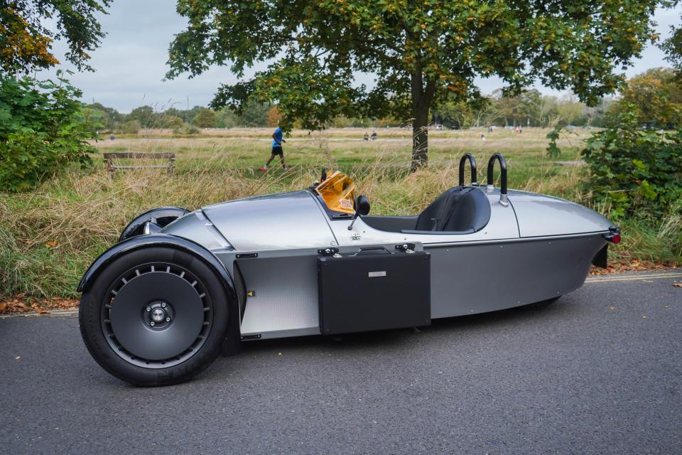 a silver car is parked on the side of the road