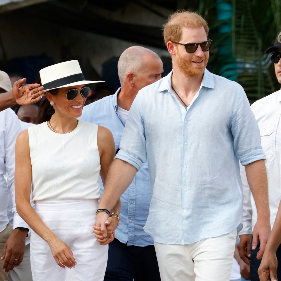 a man and a woman are holding hands and smiling