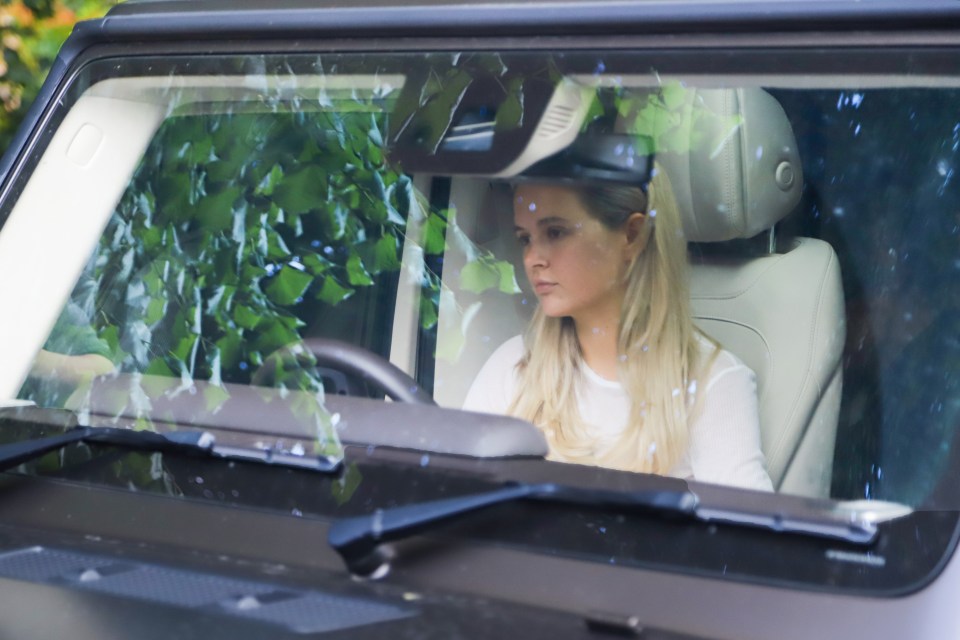 a woman is sitting in the driver 's seat of a car