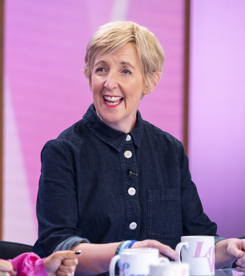 a woman sits at a table with a cup that says love on it