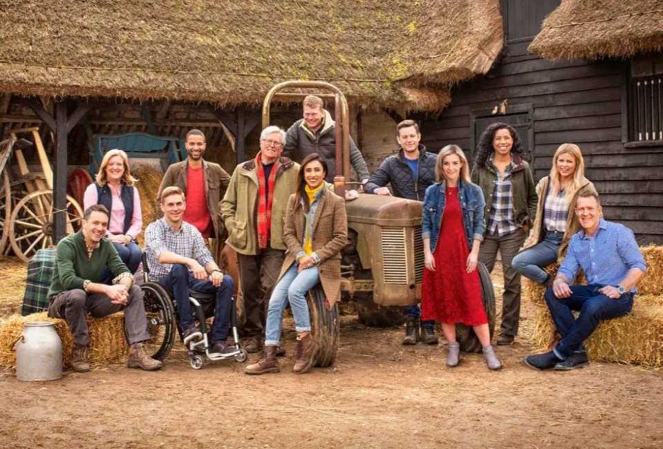 a group of people standing in front of a tractor