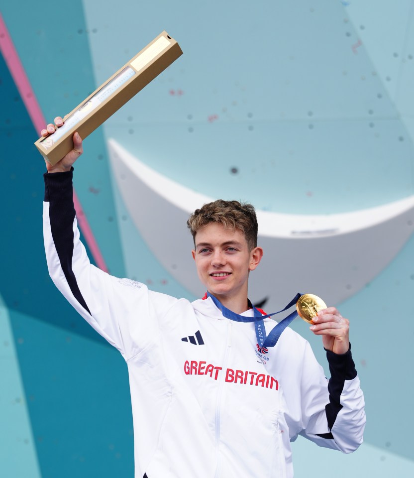 The teenager beamed with pride after being presented with his medal