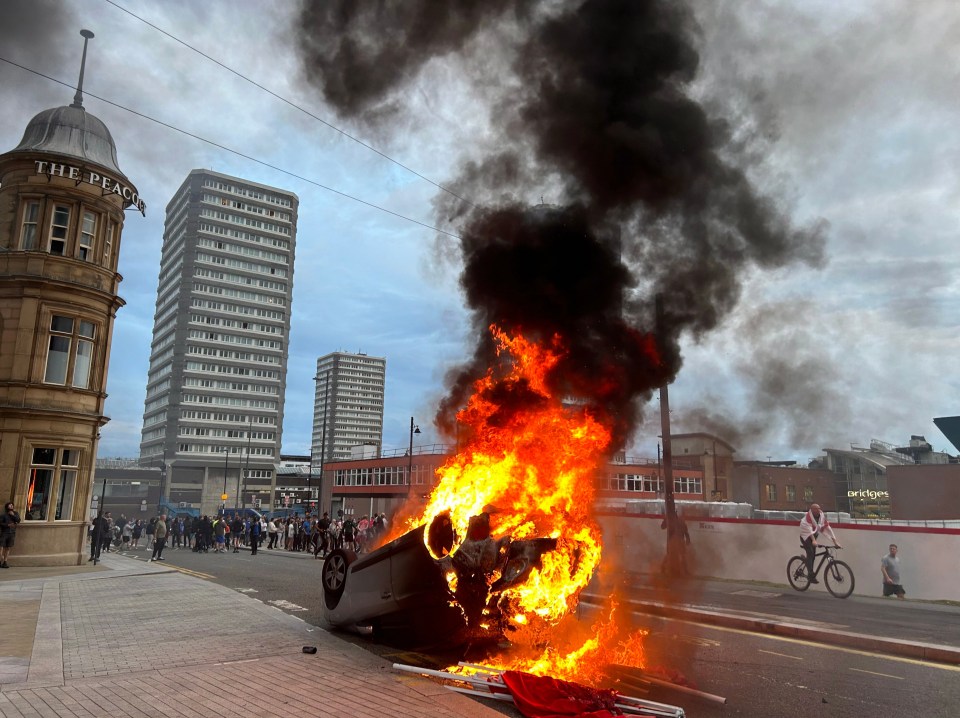 A car was flipped and set alight as crowds of thugs ran riot in Sunderland last night