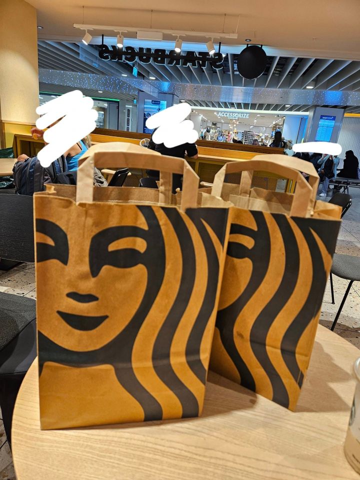 two starbucks bags are sitting on a table