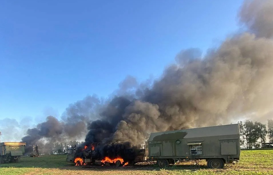 smoke coming out of a military vehicle in a field