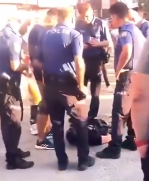 Cops stood over the teen as he was handcuffed on the ground