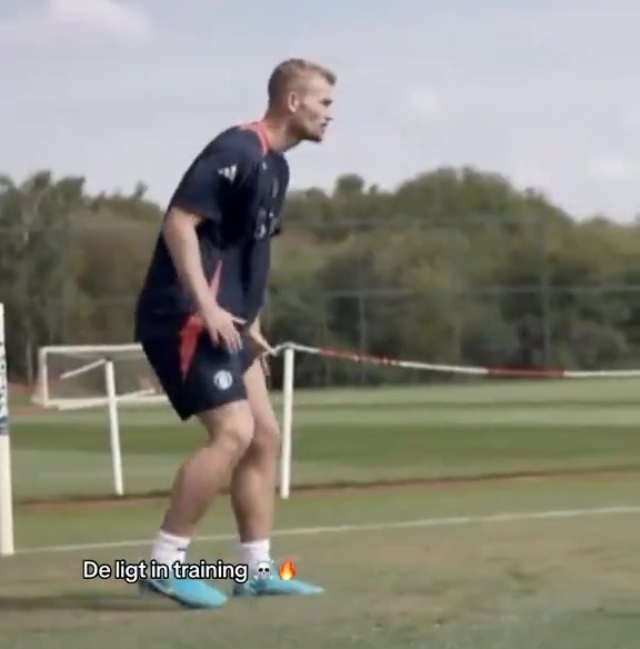 a man is standing on a soccer field with the words " de ligt in training " below him