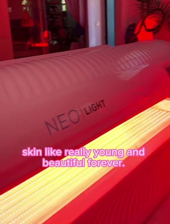 a neo light machine is in a pink room