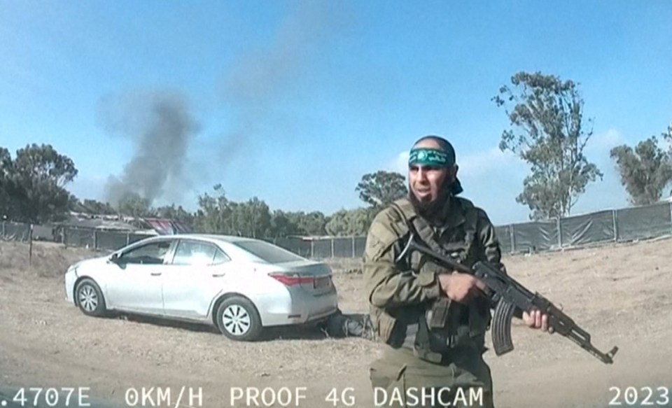 A Hamas terrorist attacking civilians at the music event during their October 7 rampage