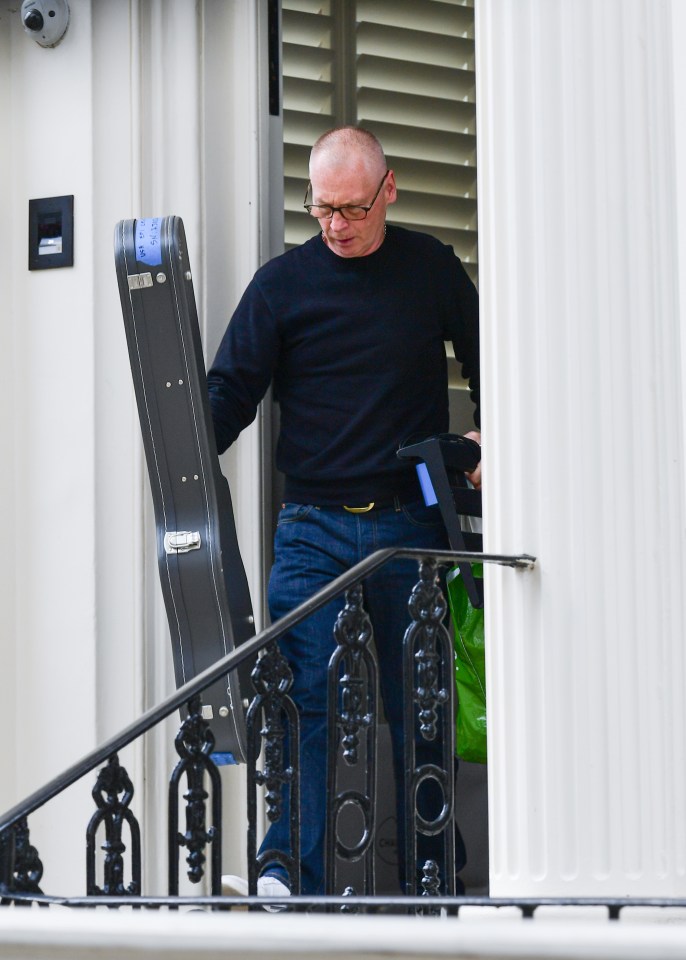 A crew member was seen carrying guitar cases at the studio