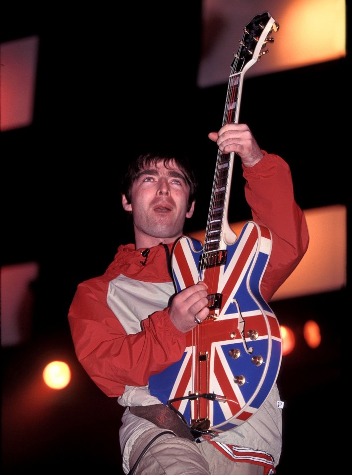 a man playing a guitar with the union jack painted on it