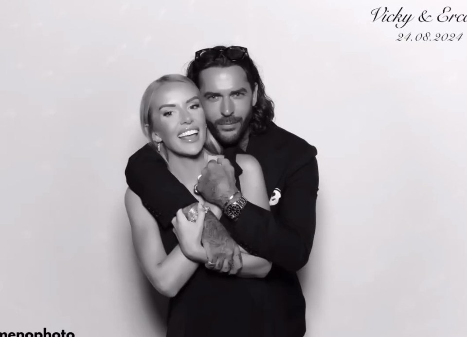 a man and a woman are posing for a photo in a photo booth