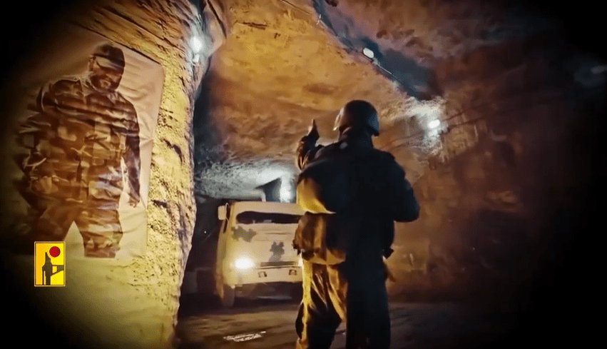 a man in a helmet stands in front of a truck in a tunnel