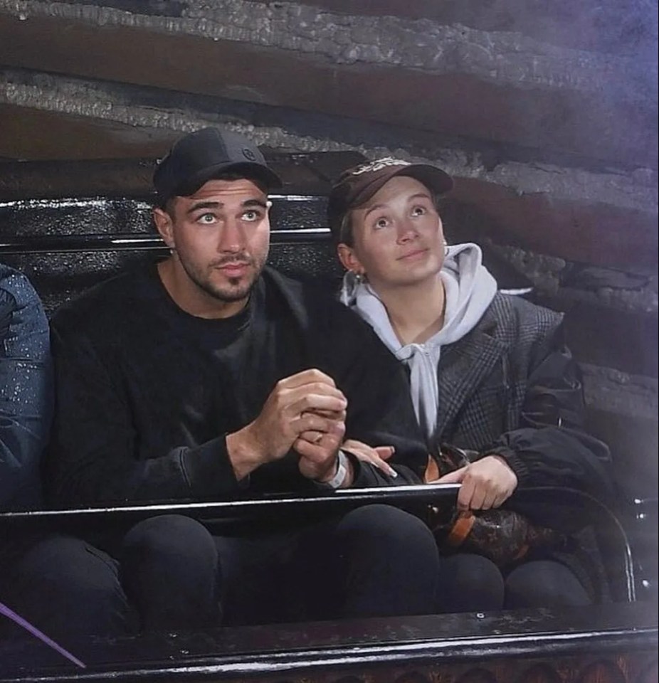 a man and a woman are riding a roller coaster together