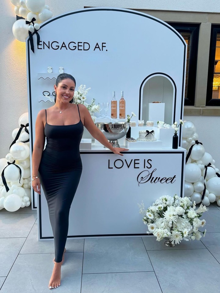 a woman stands in front of a sign that says love is sweet