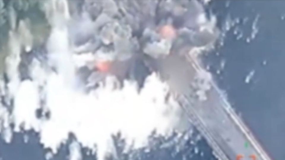 an aerial view of a bridge with smoke coming out of it