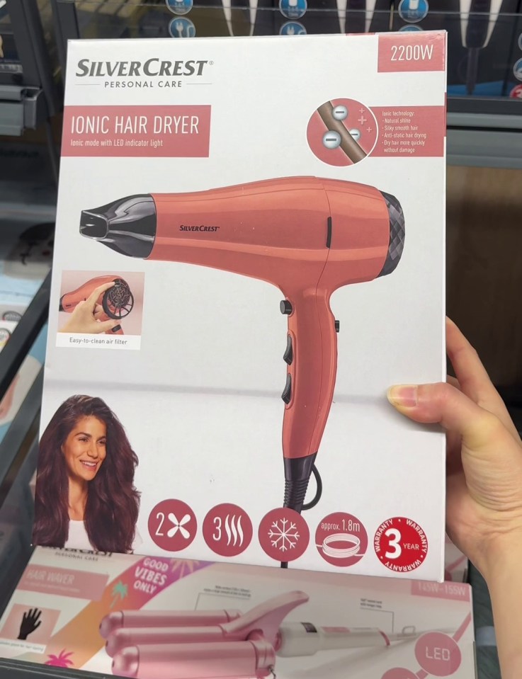 a person is holding a box of silvercrest ionic hair dryer