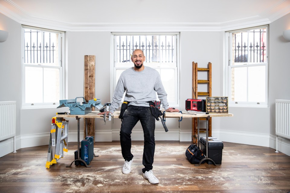 a man standing in front of a workbench with a toolbox that says bosch on it