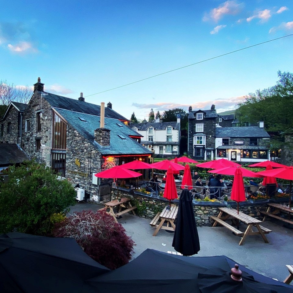 a restaurant with red umbrellas in front of it