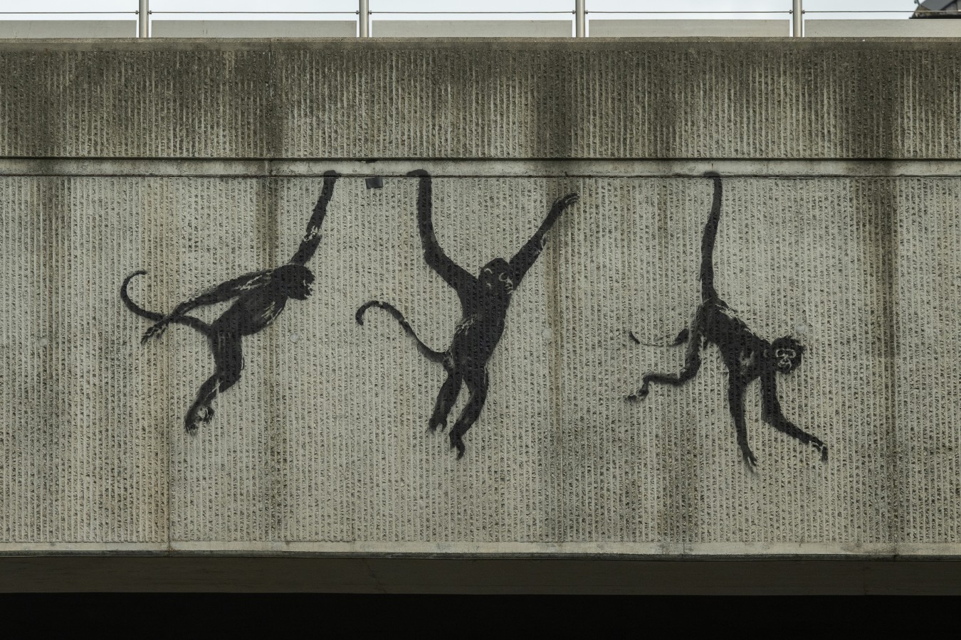 The third mural featured three monkeys hanging on a bridge on Brick Lane in London