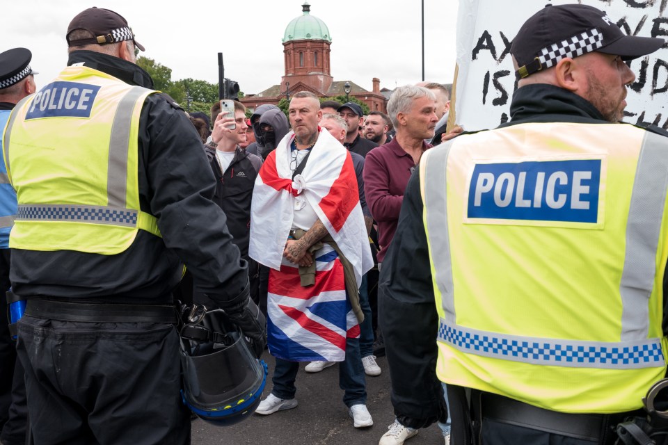 MIDDLESBROUGH, ENGLAND - AUGUST 04: Police officers respond as far-right activists hold a demonstration in Middlesbrough on August 04, 2024 in Middlesbrough, England. Yesterday saw widespread violence as Far-right agitators in Liverpool and Manchester rioted and looted shops. Police were attacked and injured and dozens of arrests were made. (Photo by Ian Forsyth/Getty Images)